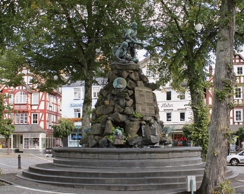  City, Urban, Architecture, Building, Monument, Car, Transportation, Vehicle, Fountain, Water, Neighborhood, Road, Street, Adult, Male, Man, Person, Plant, Tree