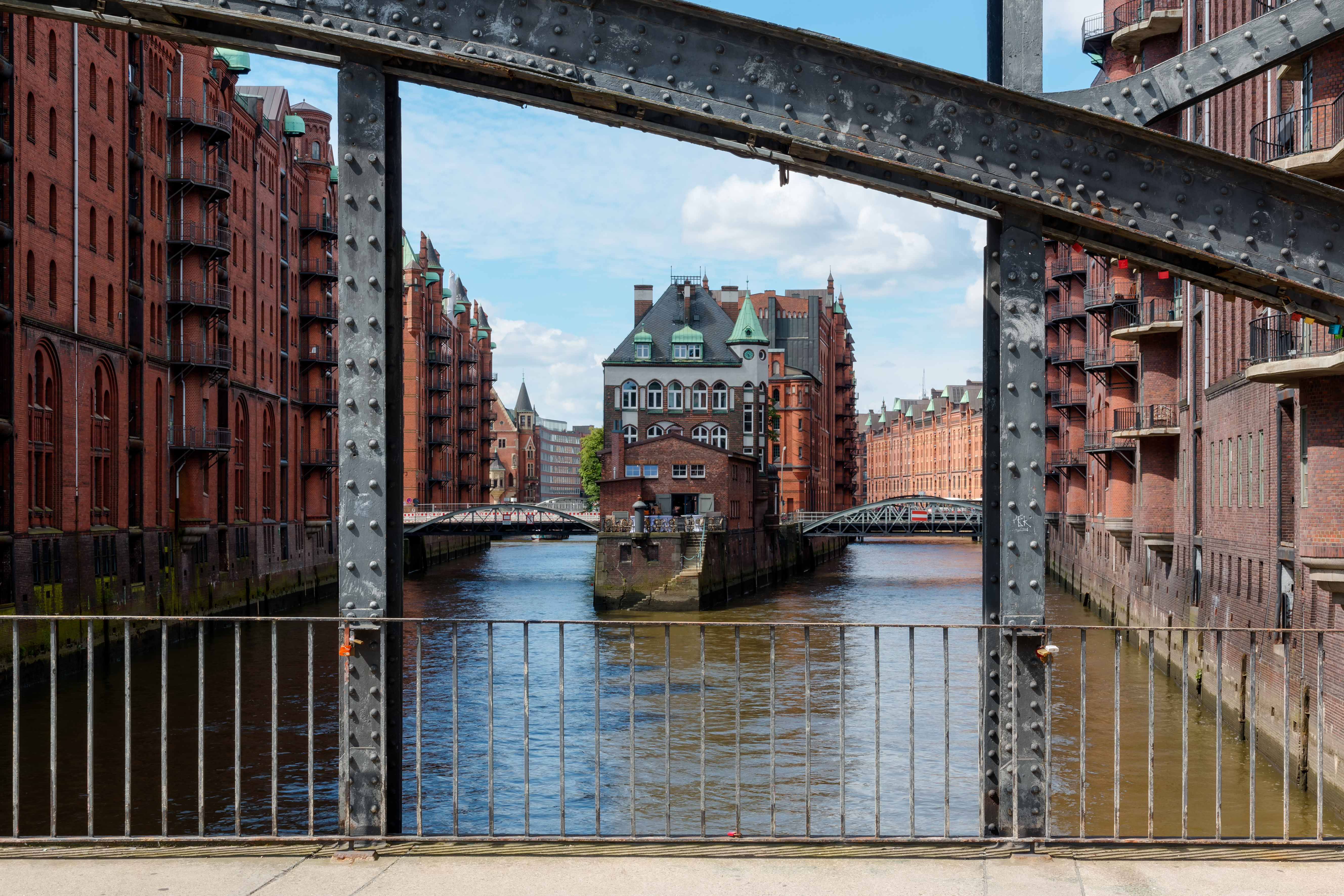  Canal, Outdoors, Water, City, Metropolis, Urban, Railing, Architecture, Building, Office Building, Handrail, Arch, Castle, Fortress, Path, Person, Brick, Waterfront