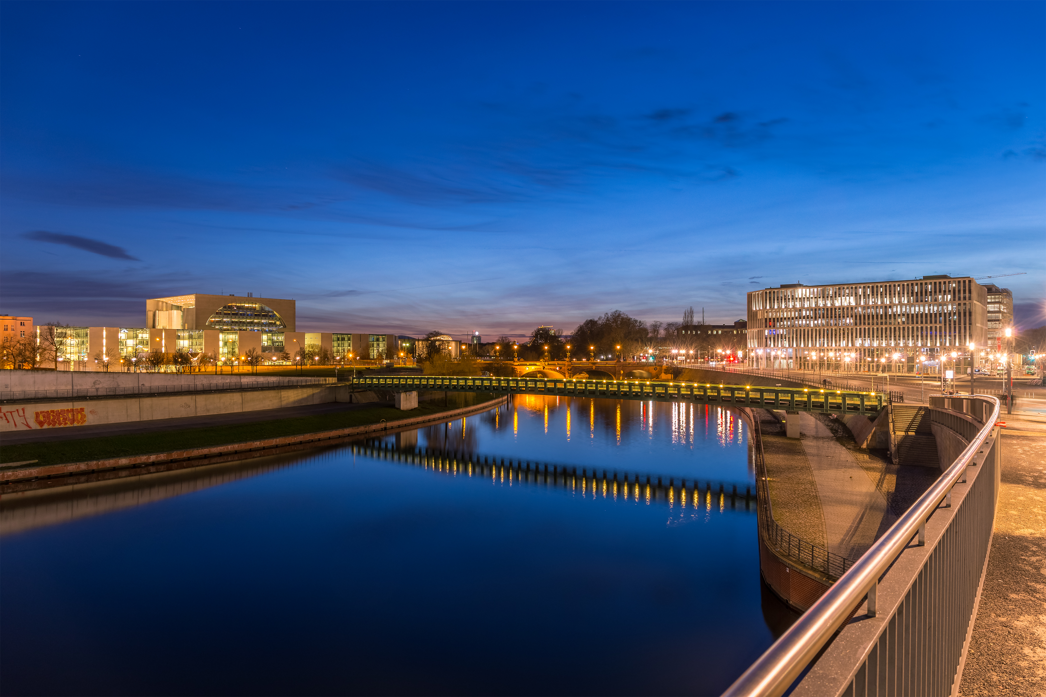  City, Metropolis, Urban, Water, Waterfront, Canal, Outdoors, Architecture, Building, Cityscape, Office Building, Nature, Scenery, Railing, Path, Car, Transportation, Vehicle