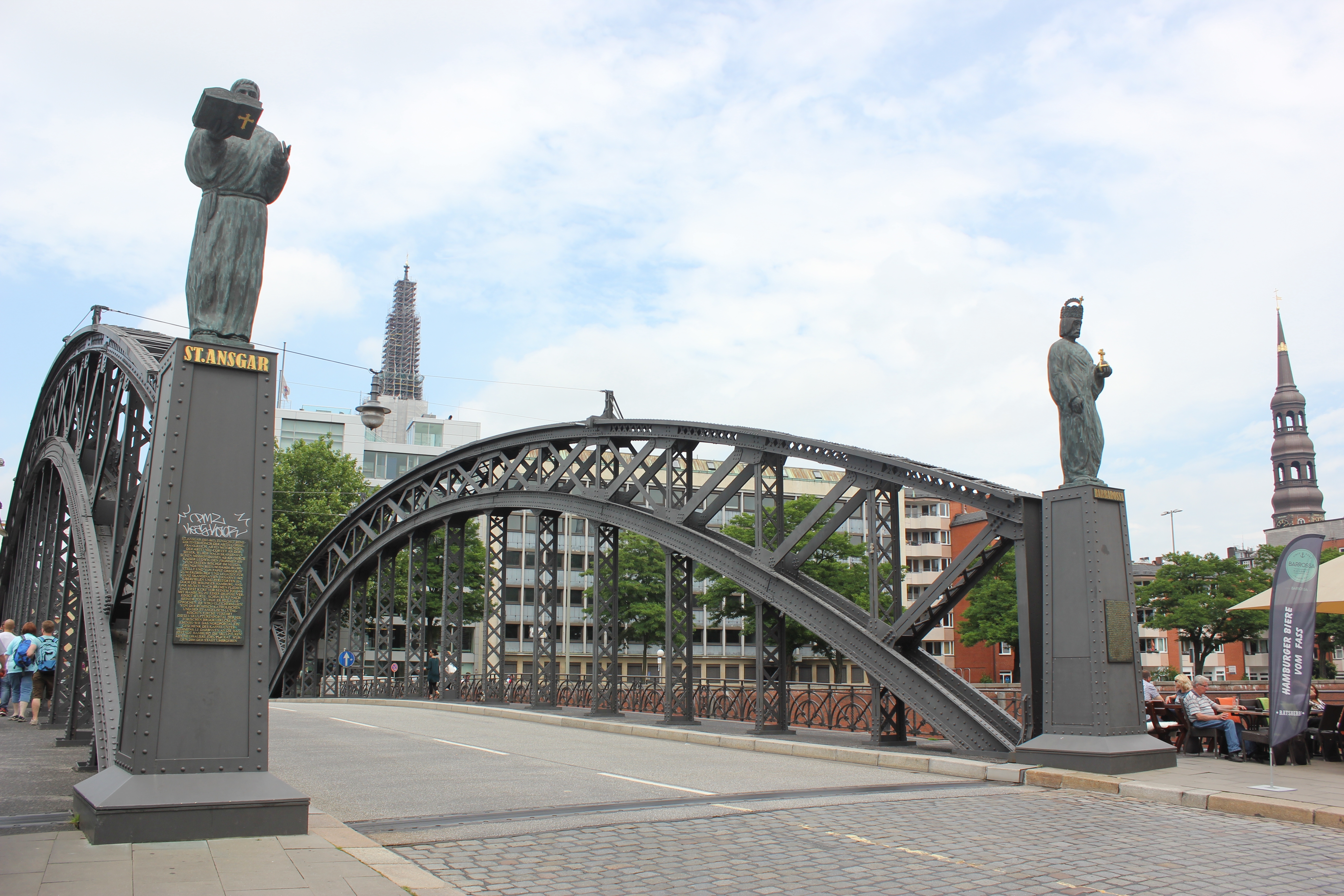  Arch, Architecture, City, Metropolis, Urban, Person, Clothing, Footwear, Shoe, Arch Bridge, Bridge, Road, Backpack, Bag, Helmet, Gothic Arch