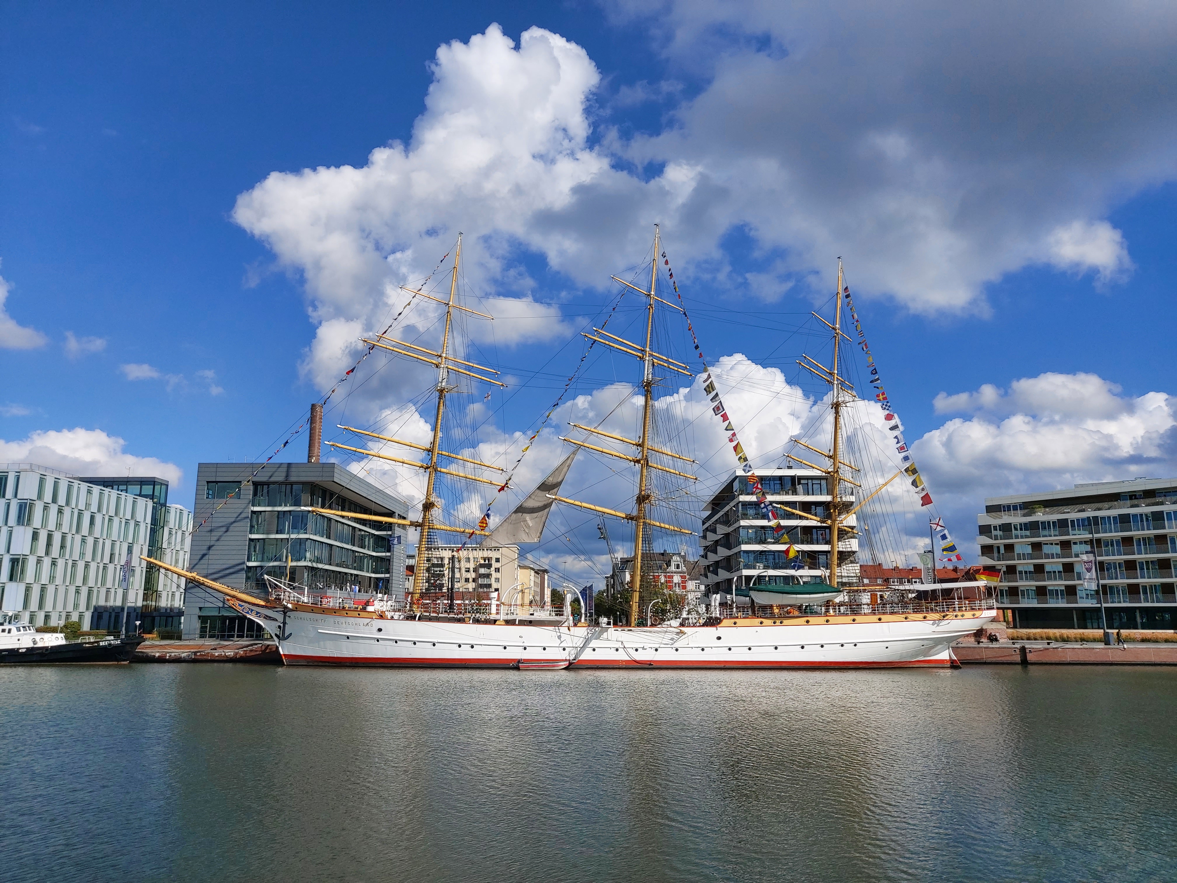  Water, Waterfront, Port, Boat, Sailboat, Transportation, Vehicle, Watercraft, Harbor, Pier, City, Person, Architecture, Building, Office Building, Urban, Nature, Outdoors, Sky
